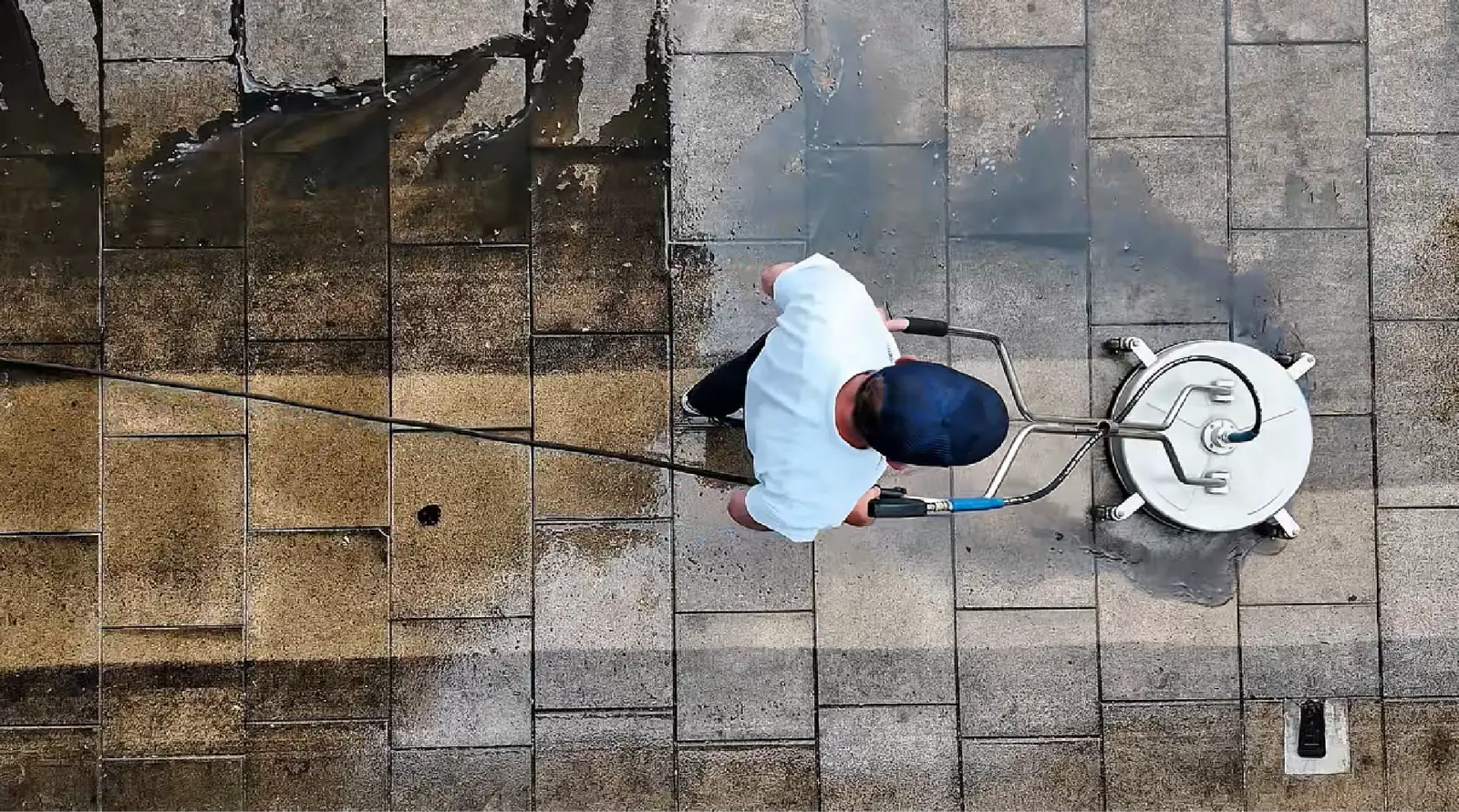 Normans Cleaning pressure washing a driveway from above